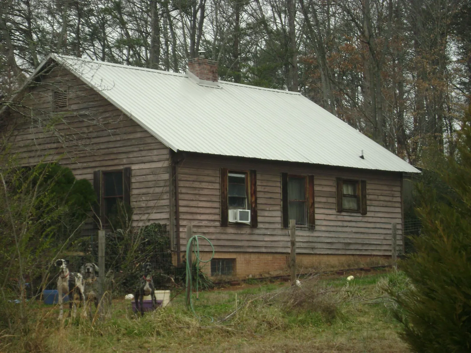 White metal roof on an old wood sided farmhouse, from a Metal Roof Installation job in Okarche